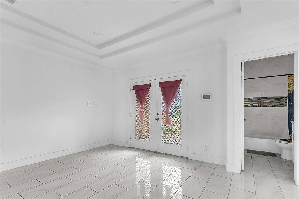 2002 Clay Street, Mabank, TX 75147 Bedroom with tray ceiling, French doors to the outside and an adjoining full bath