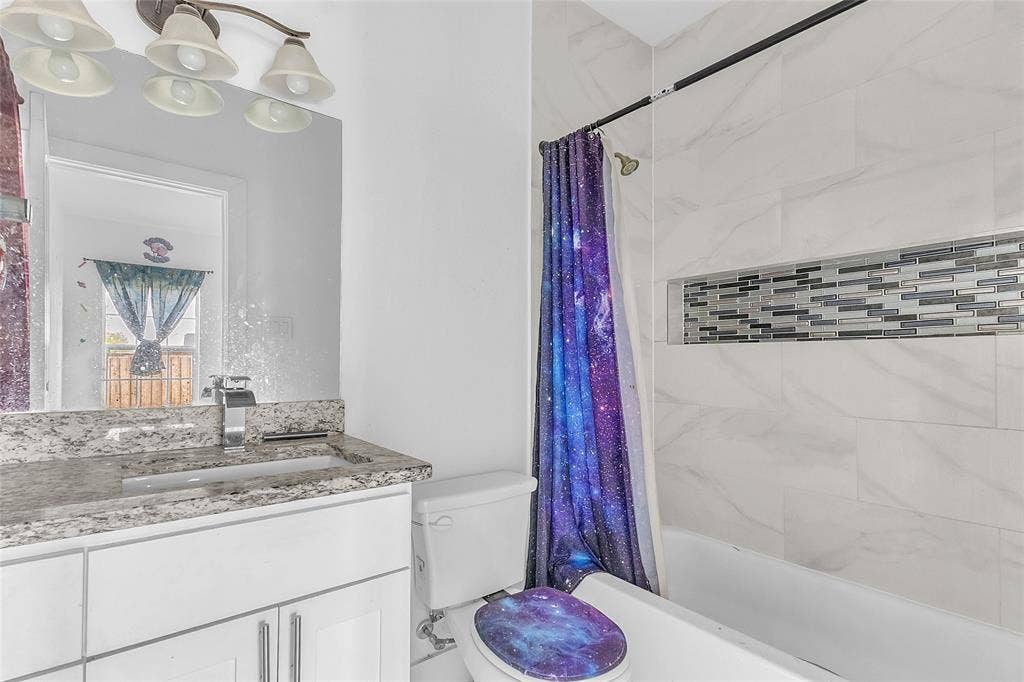 2002 Clay Street, Mabank, TX 75147 Full bath with granite-look vanity, tub and shower combo and tile wall with mosaic accent
