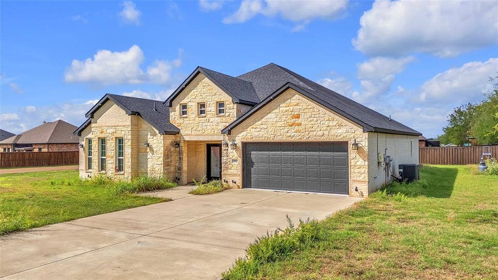 2002 Clay Street, Mabank, TX 75147 Front exterior with stone facade, double entry doors and two-car attached garage