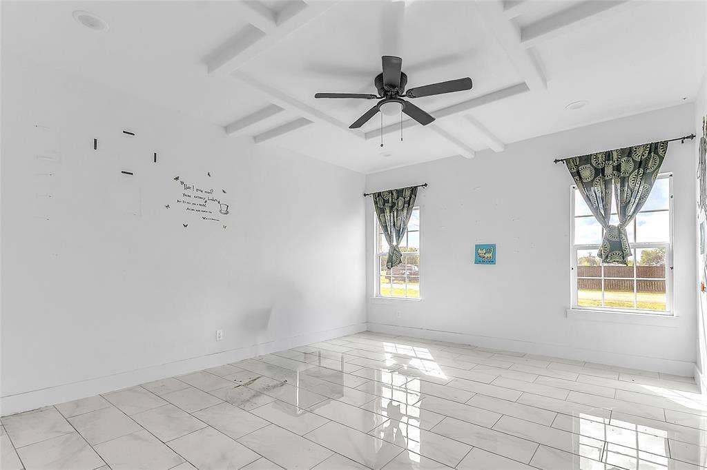 2002 Clay Street, Mabank, TX 75147 Primary bedroom with coffered ceiling, ceiling fan and windows on two sides