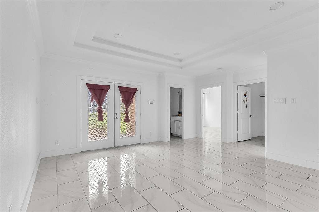 2002 Clay Street, Mabank, TX 75147 Wide hallway with glass French doors and tile flooring leading to bedrooms and baths