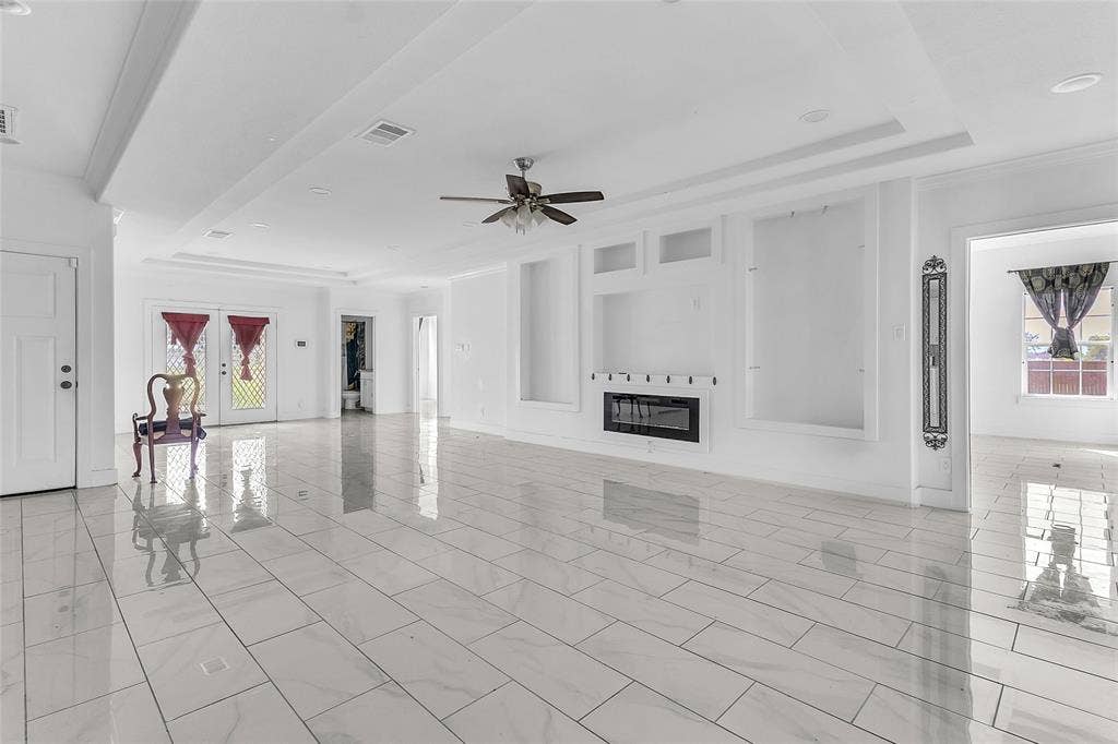 2002 Clay Street, Mabank, TX 75147 Spacious living room with tray ceiling, built-in display niches and electric fireplace