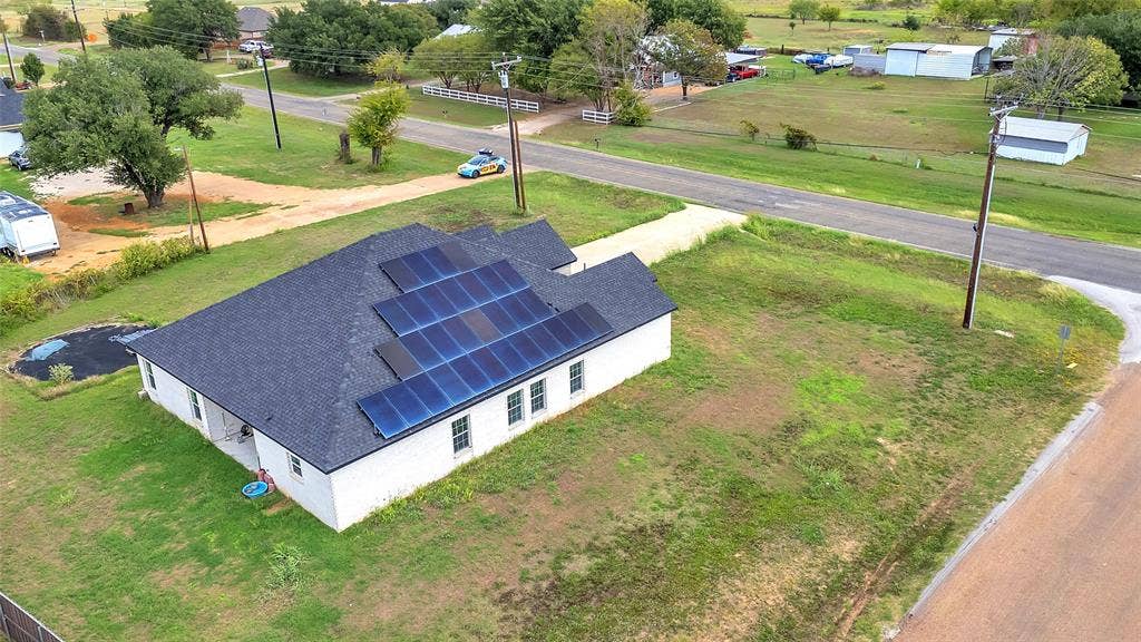 2002 Clay Street, Mabank, TX 75147 Aerial view of the home with roof solar panels on a corner lot with a paved street