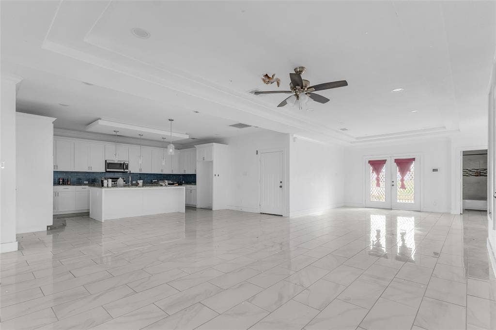 2002 Clay Street, Mabank, TX 75147 Open living space with tray ceiling, ceiling fan and tile floors flows into the kitchen