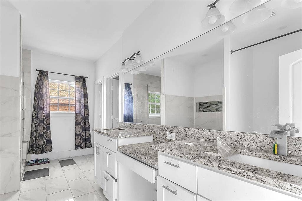 2002 Clay Street, Mabank, TX 75147 Primary bath double vanity with granite-look counters, makeup area and a large mirror