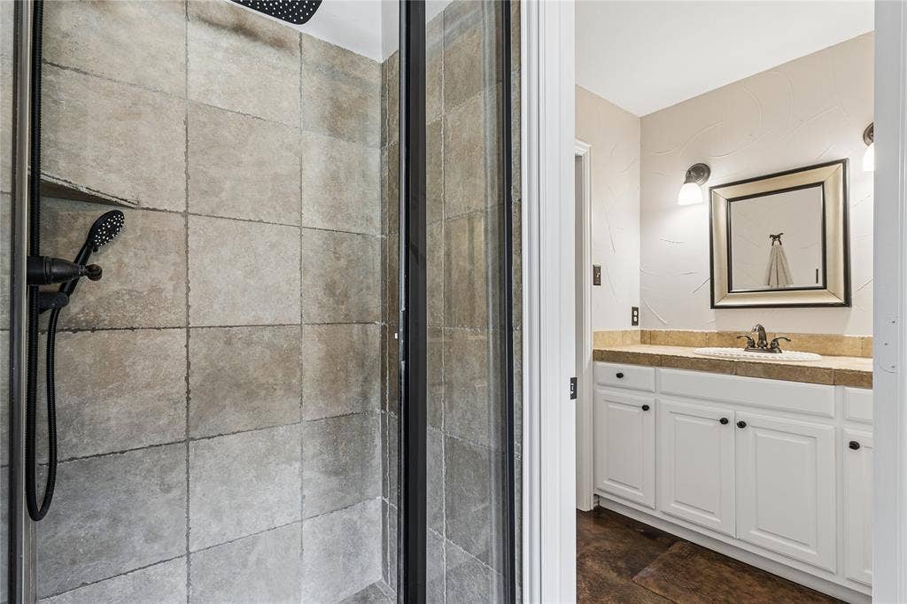Primary bathroom features his & hers vanities and closets.