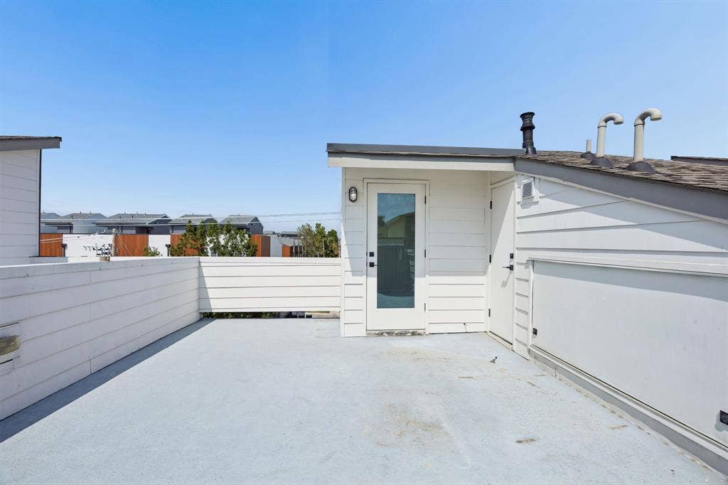 1901 N Carroll Avenue, #104, Dallas, TX 75204 Rooftop terrace featuring horizontal wood-finish siding, a solid surface deck, and white perimeter fencing