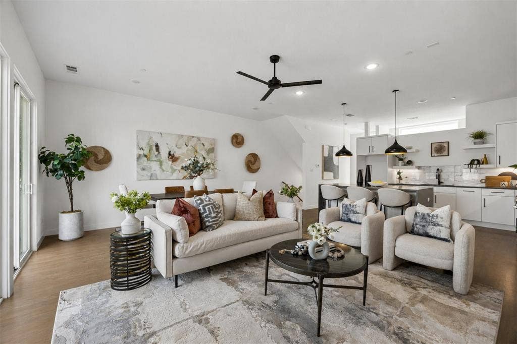 1901 N Carroll Avenue, #104, Dallas, TX 75204 Open-concept interior featuring wood-finish flooring, recessed lighting, a modern ceiling fan, and a kitchen equipped with cabinetry and stone-finish countertops