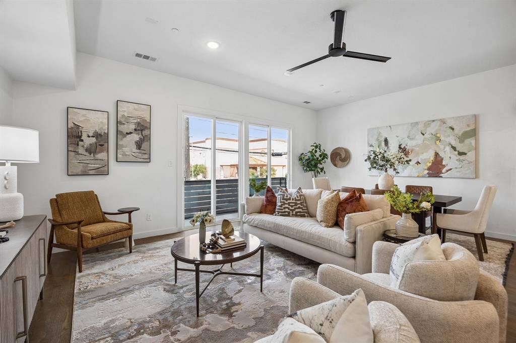 1901 N Carroll Avenue, #104, Dallas, TX 75204 Open floor plan featuring wood-finish flooring, recessed lighting, matte black ceiling fan, and sliding glass doors with exterior balcony access