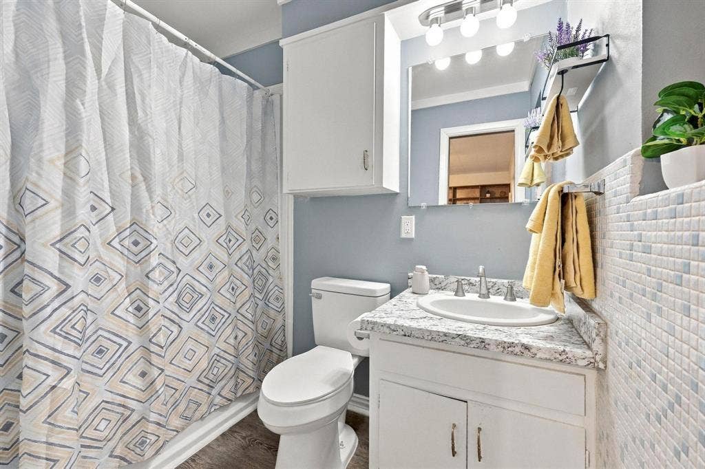 Bathroom featuring a vanity with a shower/tub combo