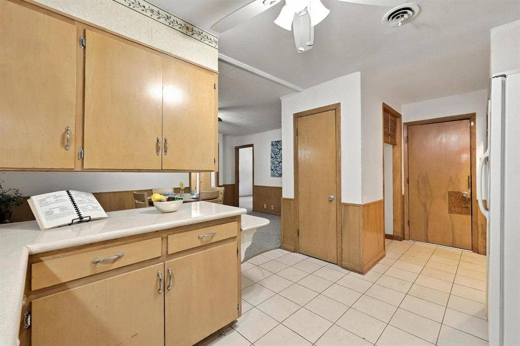 Built in cabinetry with double oven, stove top, plenty of cabinetry and a multi-level peninsula with a countertop extension