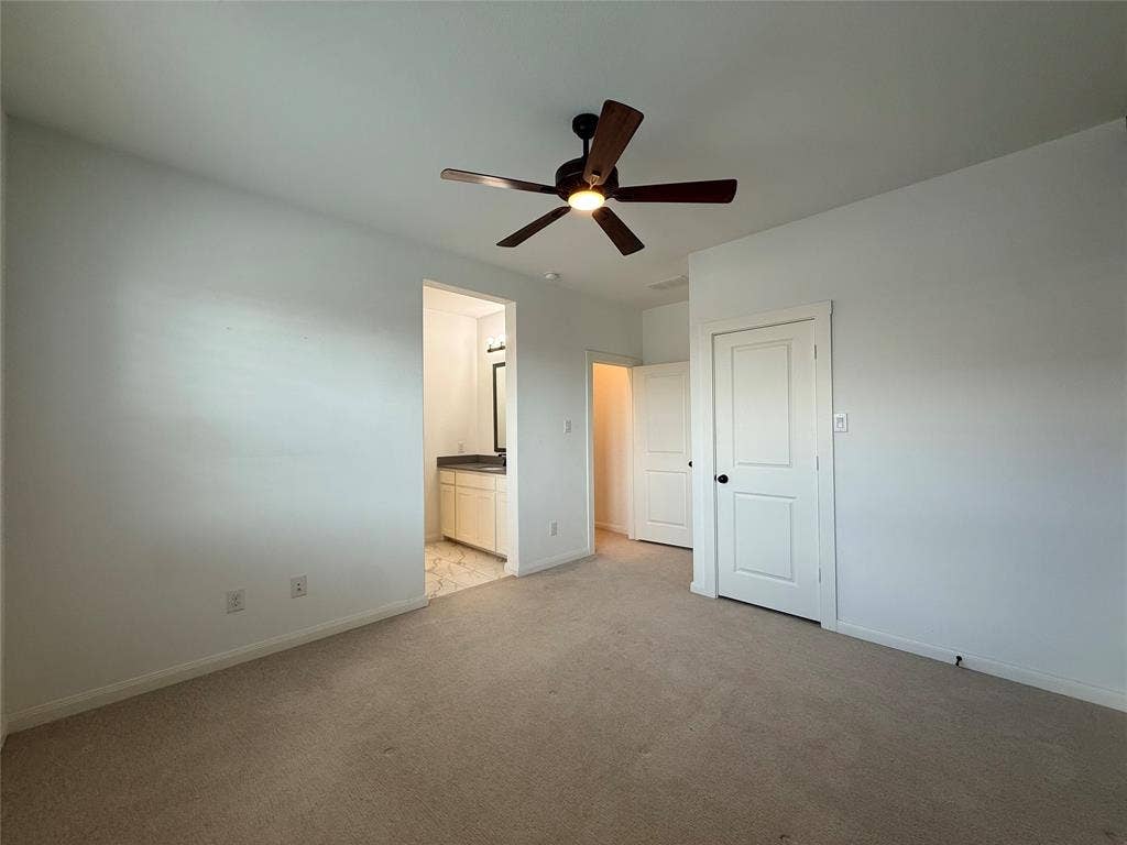 12905 Yale Court, Frisco, TX 75035 Neutral-toned carpeting, ceiling fan with integrated lighting, and white paneled doors