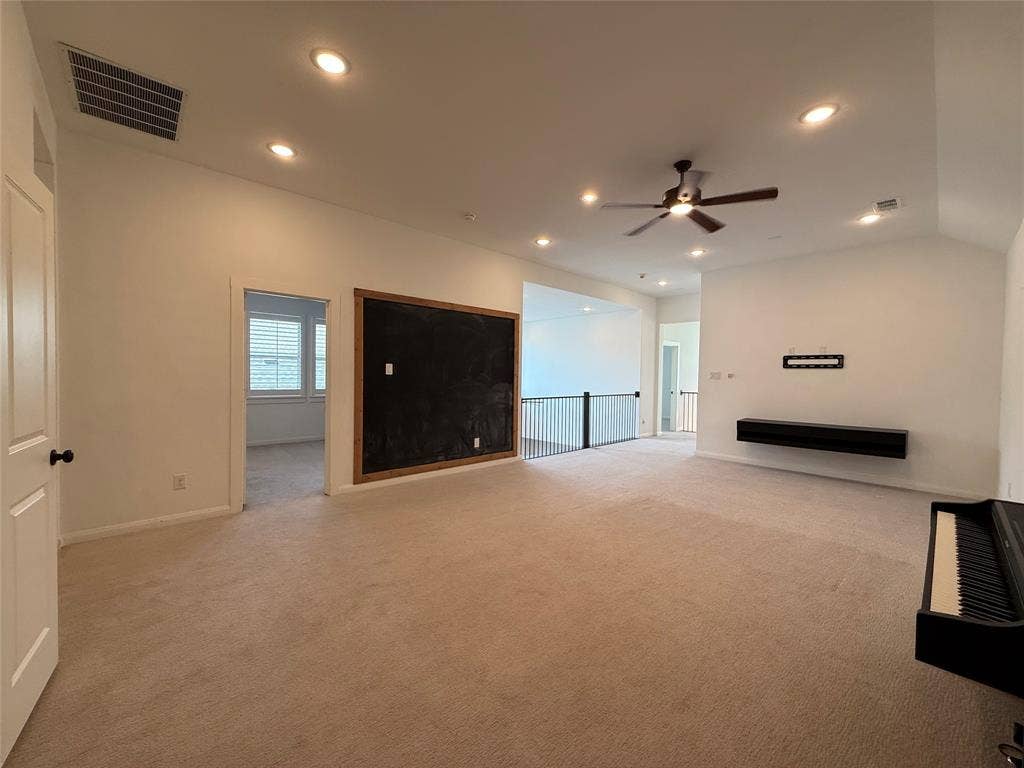 12905 Yale Court, Frisco, TX 75035 Vaulted ceilings featuring recessed lighting and a ceiling fan, a large framed wall-mounted chalkboard, and a dark-finished floating media console