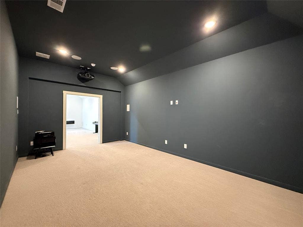 12905 Yale Court, Frisco, TX 75035 Vaulted ceilings, dark-toned interior walls, integrated ceiling-mounted lighting, and neutral carpeting