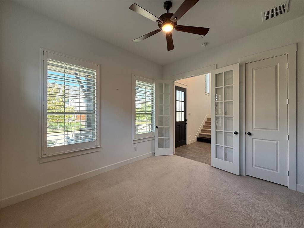 12905 Yale Court, Frisco, TX 75035 Room featuring plantation shutters, neutral carpeting, a ceiling fan with integrated lighting, and French doors