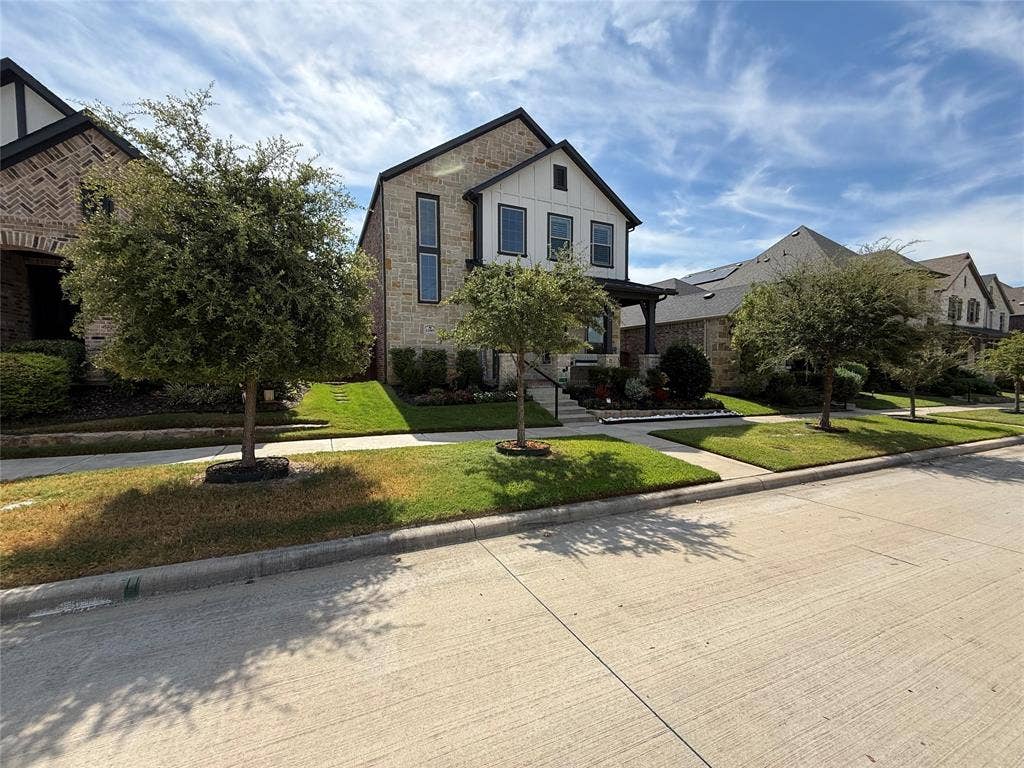 12905 Yale Court, Frisco, TX 75035 Multi-story residence with a stone and board-and-batten facade, peaked rooflines, and manicured landscaping