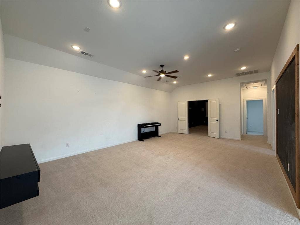 12905 Yale Court, Frisco, TX 75035 Spacious interior featuring high ceilings, recessed lighting, a ceiling fan, neutral carpeting, and white double doors