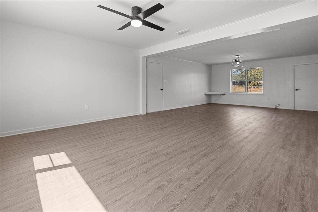 17014 Woodcrest Circle, Lindale, TX 75771 Spacious interior featuring wood-finish flooring, recessed lighting, a modern ceiling fan, and a built-in wall desk