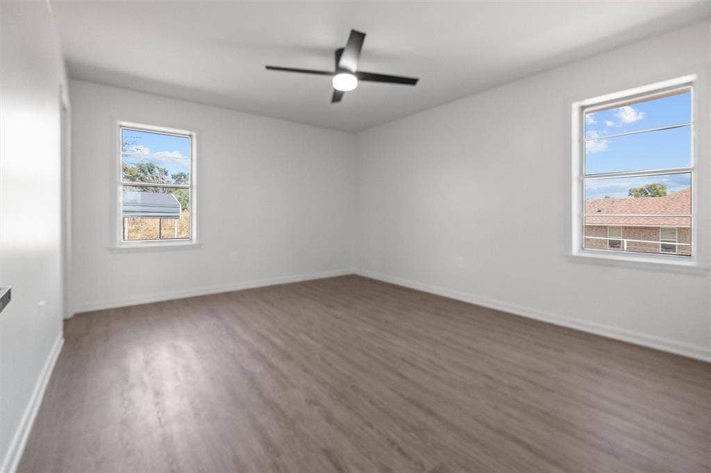 17014 Woodcrest Circle, Lindale, TX 75771 Interior space featuring wood-finish flooring, dual windows, and a ceiling fan with integrated lighting