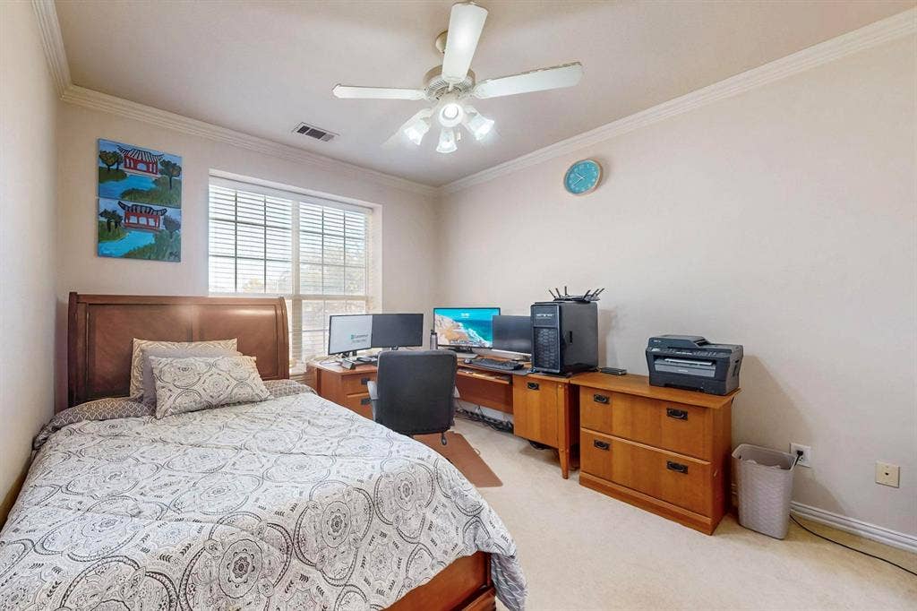 2606 Rue De Ville, Irving, TX 75038 Neutral-toned room featuring a multi-light ceiling fan, crown molding, and carpeting