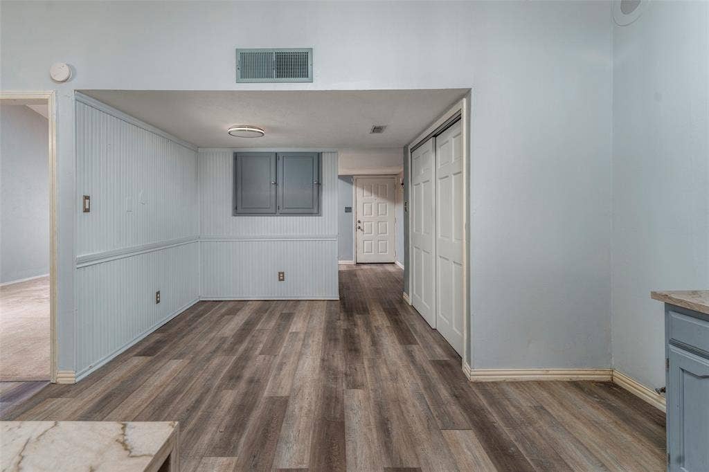 826 Camino Court, Grand Prairie, TX 75052 Interior space featuring beadboard wainscoting, wood-finish flooring, dual-panel closet doors, and recessed lighting