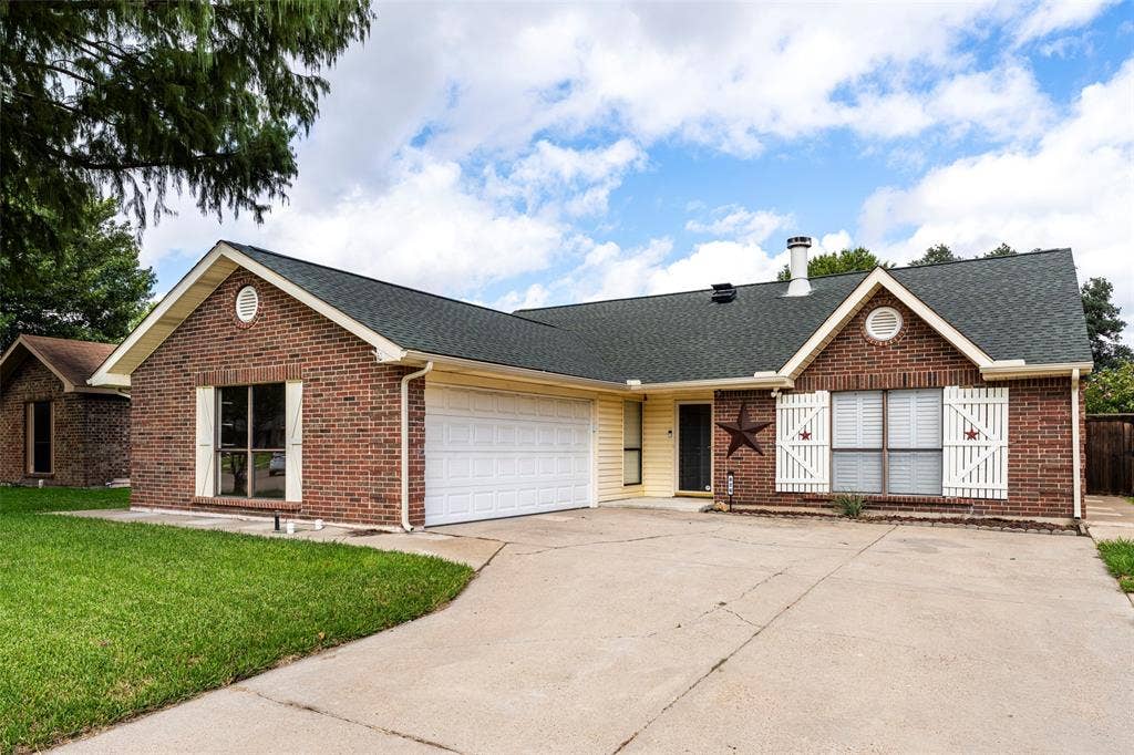 826 Camino Court, Grand Prairie, TX 75052 Brick exterior with gabled roofline, dual-gabled façade, white louvered window shutters, concrete driveway, and attached two-car garage
