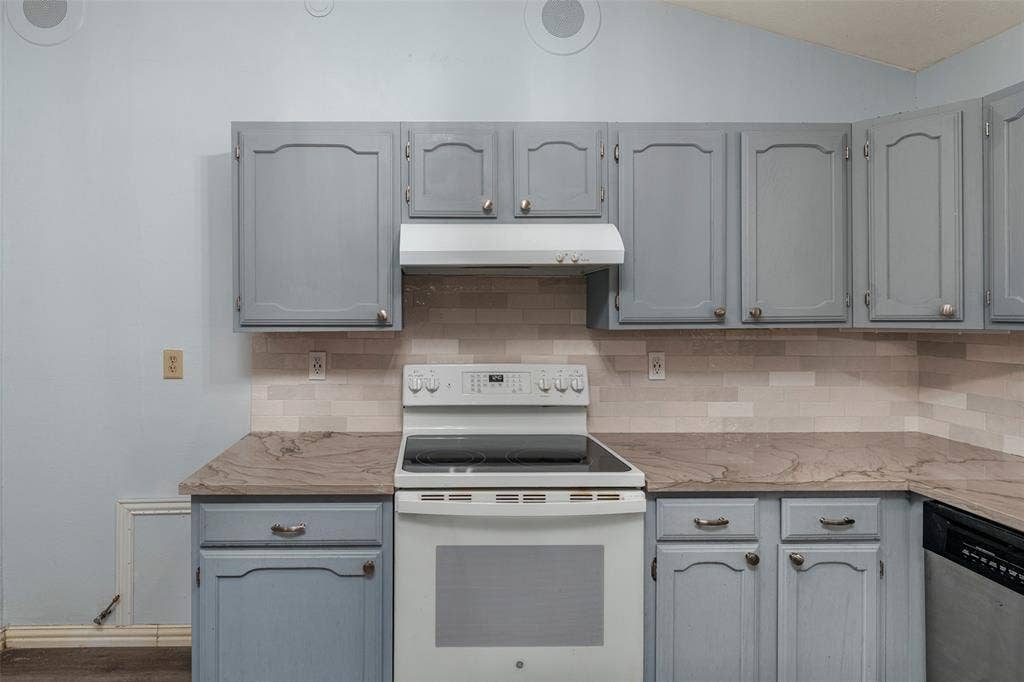 826 Camino Court, Grand Prairie, TX 75052 Kitchen featuring grey cabinetry, stone-finish countertops, tiled backsplash, and built-in appliances including an electric range and vent hood