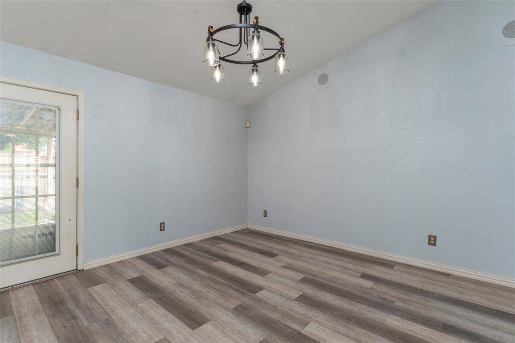 826 Camino Court, Grand Prairie, TX 75052 Vaulted ceilings, wood-finish flooring, and a multi-light metal chandelier