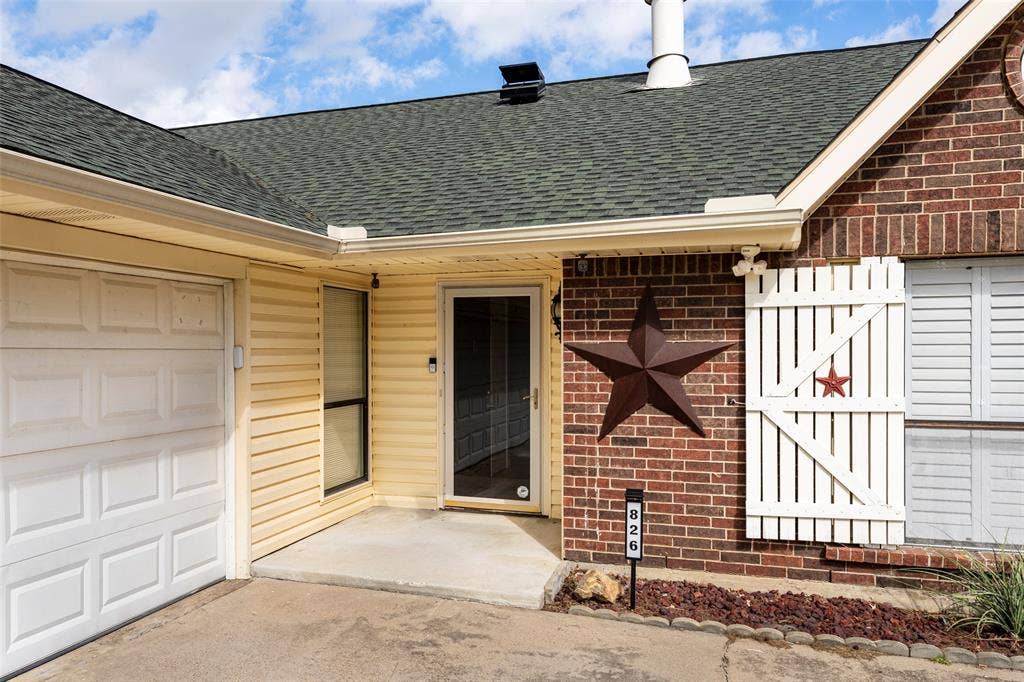 826 Camino Court, Grand Prairie, TX 75052 Exterior featuring a combination of brick masonry and horizontal siding, an attached garage with a multi-panel door, and white louvered window shutters