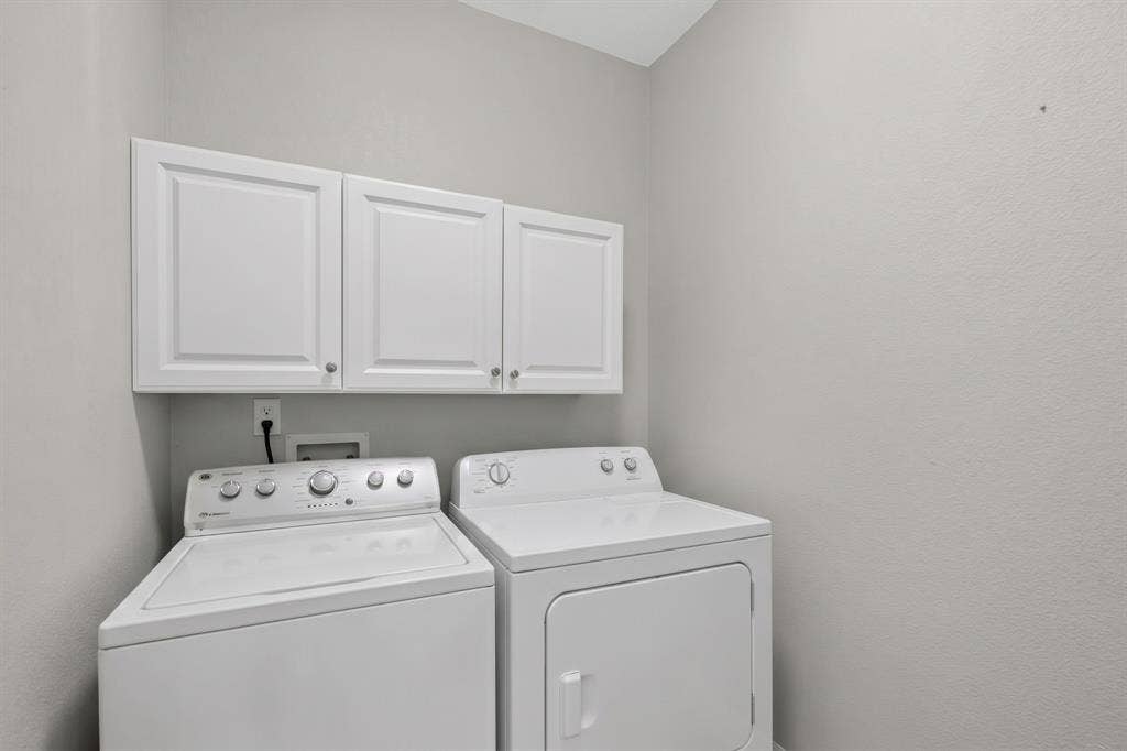Built-in white shaker-style cabinetry with matte hardware providing overhead storage