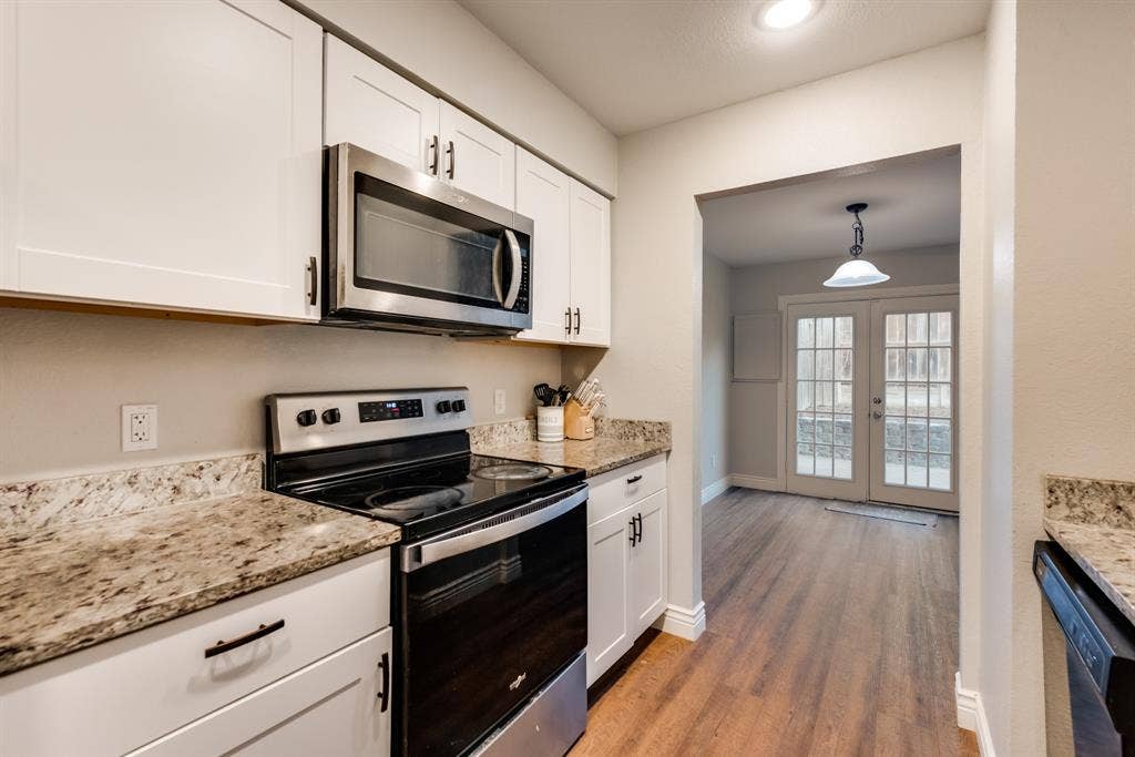 Kitchen with included microwave and electric stove top and oven.
