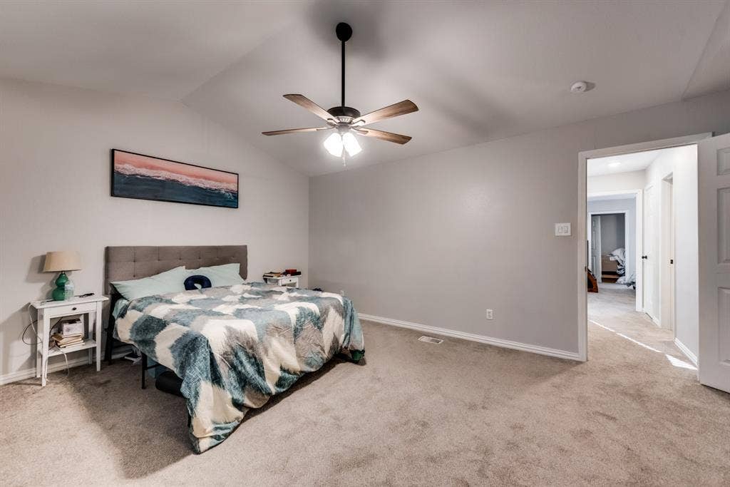 Primary bedroom with vaulted cellings.