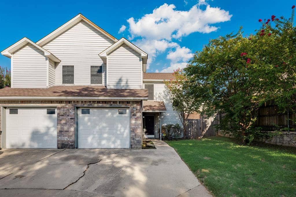 Front of the home with a driveway and garage.