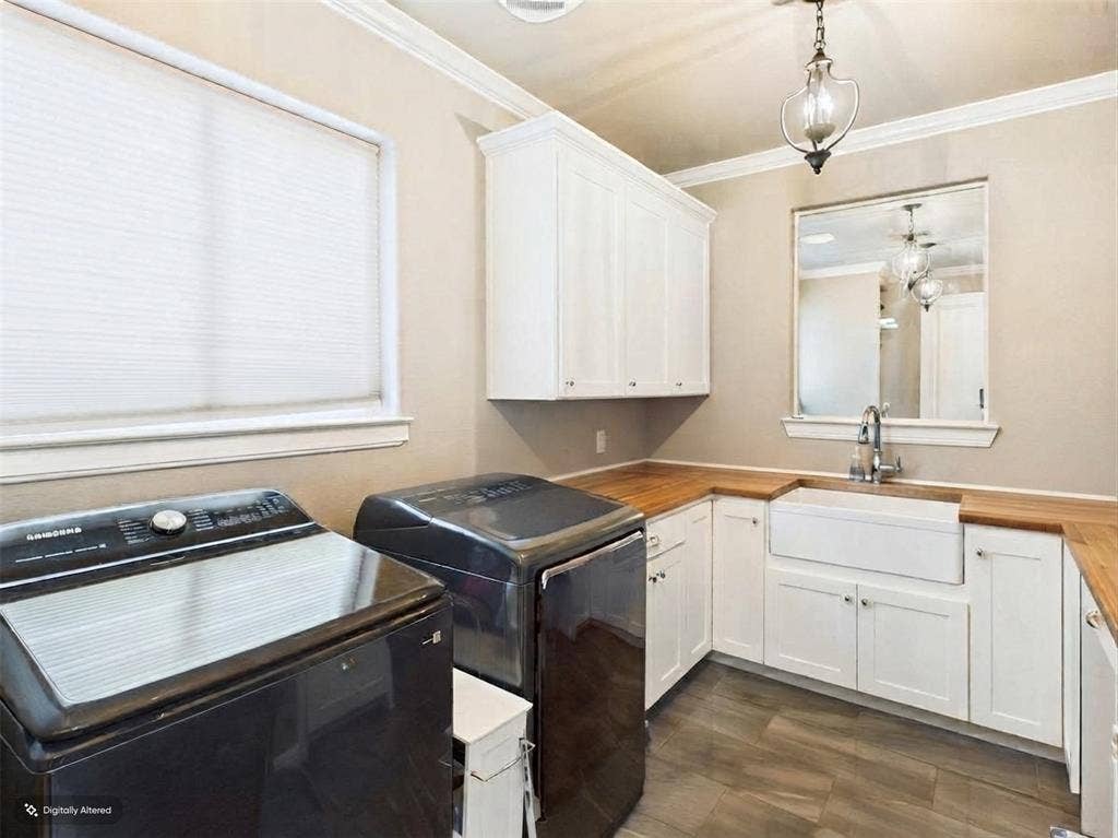 1201 E Iberian Court, Granbury, TX 76048 White cabinetry, butcher block countertop, porcelain farmhouse sink, wood-finish flooring, and crown molding