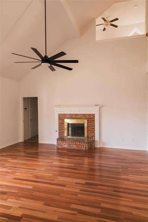 404 Belmont Court, Lewisville, TX 75067 Vaulted ceilings, wood-finish flooring, brick fireplace with a custom mantel, and multi-blade ceiling fan