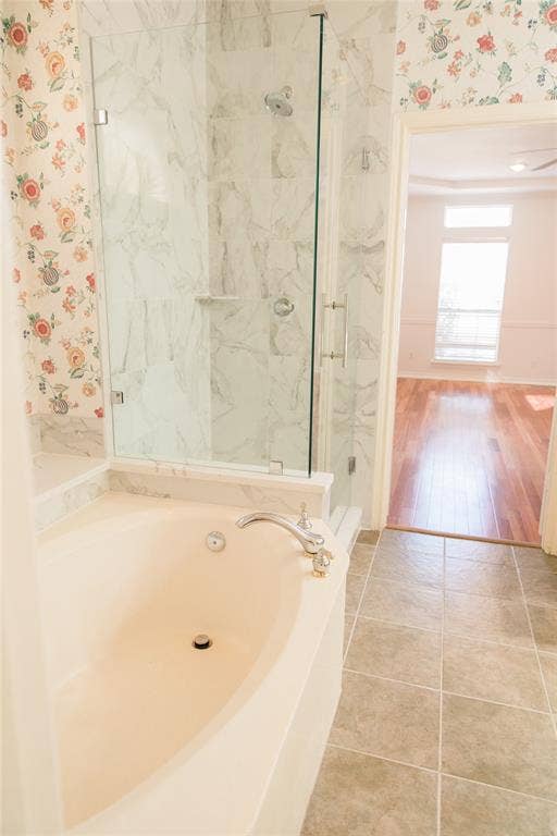 404 Belmont Court, Lewisville, TX 75067 Oval soaking tub with deck-mounted faucet, walk-in shower with glass enclosure, and tile flooring