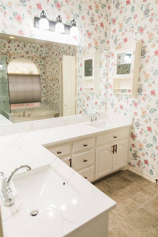404 Belmont Court, Lewisville, TX 75067 Double vanity featuring quartz countertops, undermount sinks, chrome fixtures, built-in cabinetry, and wall-mounted storage units