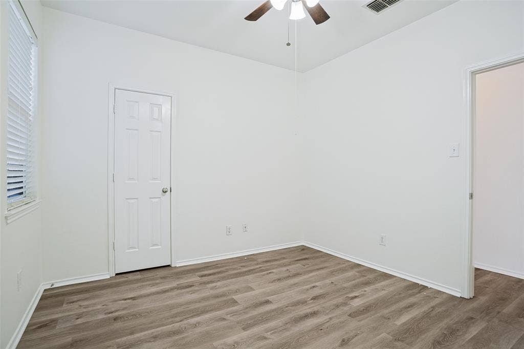 1507 Bankston Drive, Wylie, TX 75098 Interior space featuring wood-finish flooring, a neutral color palette, and an overhead ceiling fan with integrated lighting