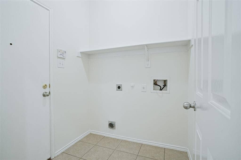 1507 Bankston Drive, Wylie, TX 75098 Utility area featuring tiled flooring, a built-in overhead shelf, and dedicated water, electrical, and ventilation hookups