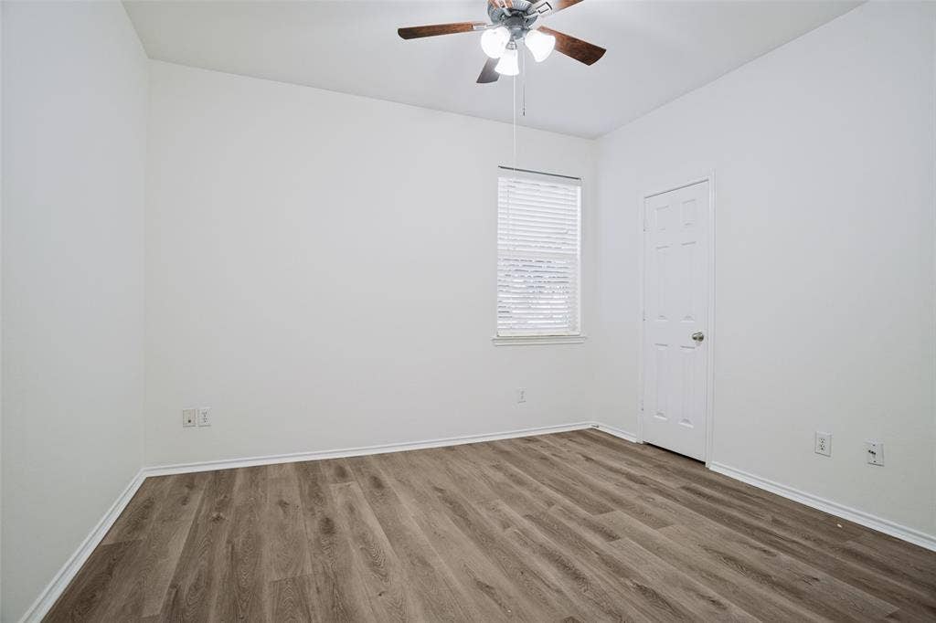 1507 Bankston Drive, Wylie, TX 75098 Room featuring wood-finish flooring, a ceiling fan with integrated lighting, and a window with fitted blinds