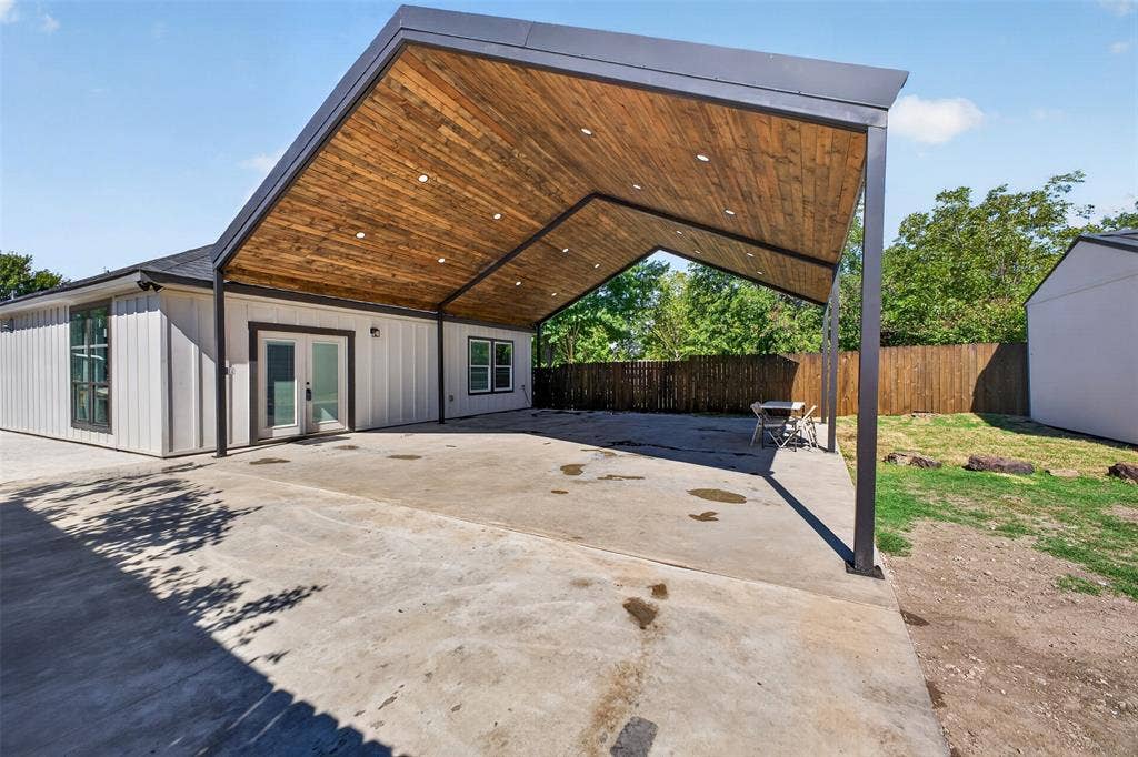 9116 Beckleycrest Avenue, Dallas, TX 75232 Brand New 30 X 30 covered patio with beautiful wood paneled vaulted ceilings, exposed beams, and recessed lighting. This impressive 900 sq foot space offers plenty of room for outdoor entertaining or covered parking up to four vehicles.