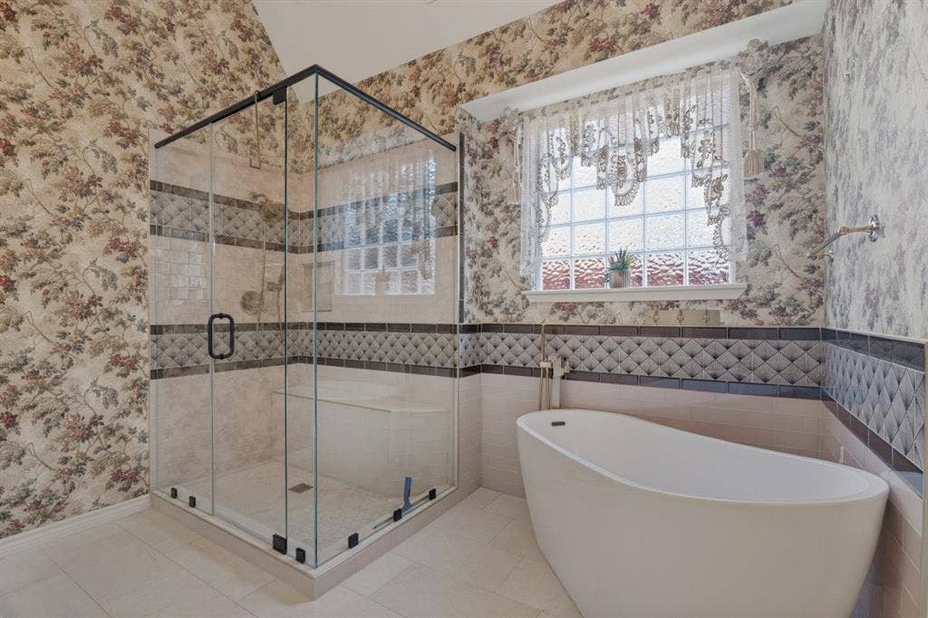 primary bathroom with walk in shower and tub