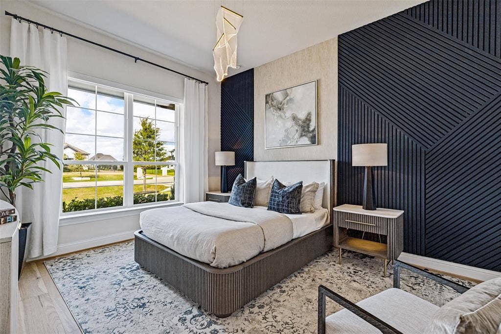 4604 Devon Drive, Parker, TX 75002 Geometric slat wall paneling, expansive multi-pane windows, wood-finish flooring, and a contemporary architectural pendant light fixture