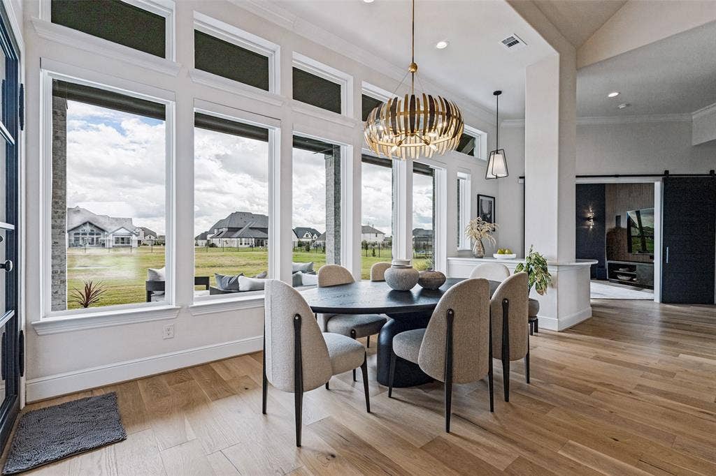 4604 Devon Drive, Parker, TX 75002 Floor-to-ceiling windows, wood-finish flooring, custom statement chandelier, high ceilings, and sliding barn-style door