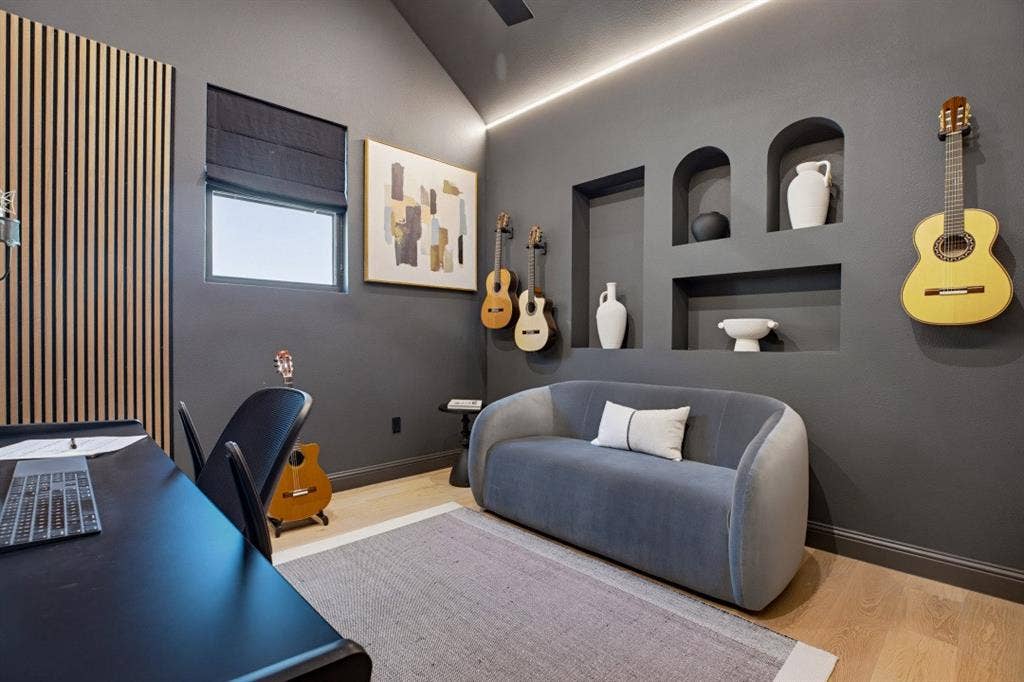 4604 Devon Drive, Parker, TX 75002 Vaulted ceiling featuring integrated cove lighting, vertical wood-slat accent wall, custom built-in wall niches, and light-tone wood-finish flooring