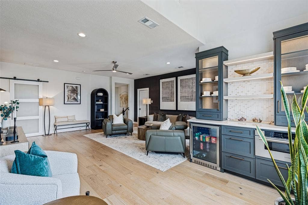 4604 Devon Drive, Parker, TX 75002 Open concept living space featuring wood-finish flooring, recessed lighting, and custom cabinetry with integrated glass-front display towers