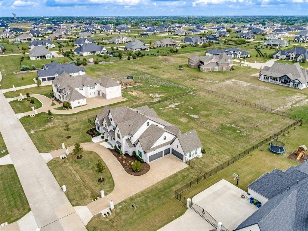 4604 Devon Drive, Parker, TX 75002 Aerial perspective of a multi-gabled residence featuring a concrete driveway, attached multi-car garage, and a sprawling, fenced lot