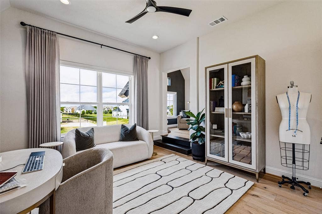 4604 Devon Drive, Parker, TX 75002 Room featuring wood-finish flooring, high ceilings, large multi-pane windows, and a black matte ceiling fan