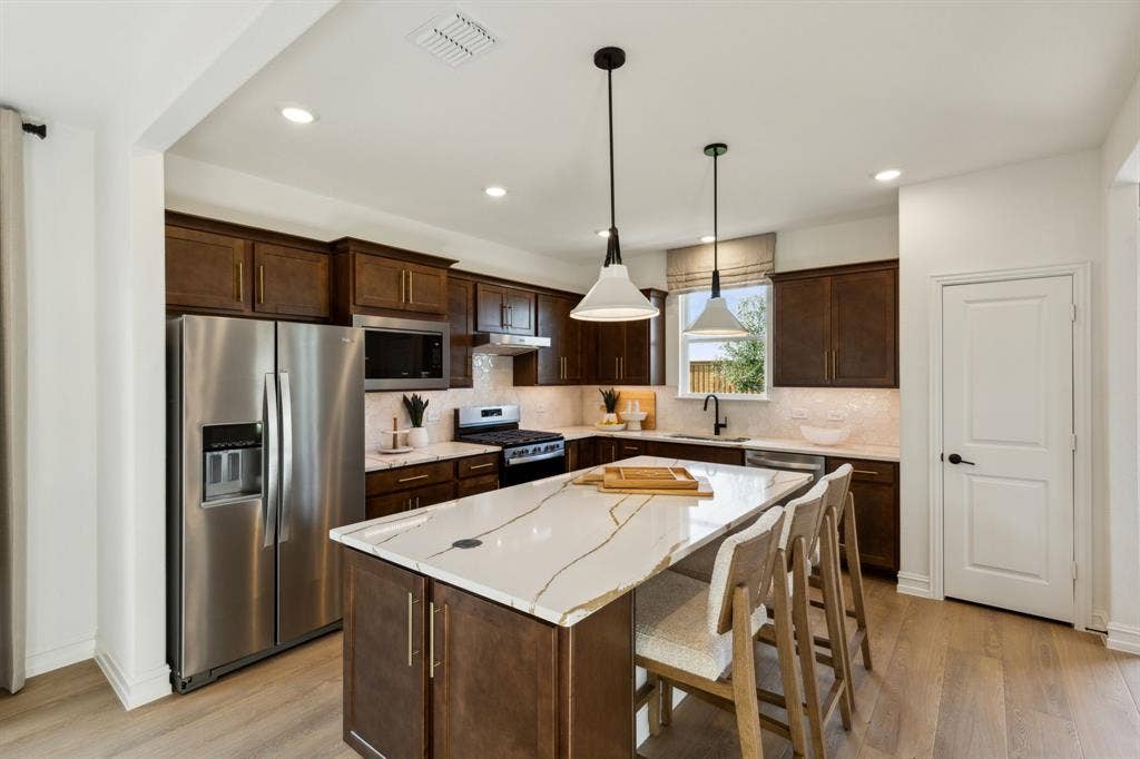 304 Snowbird Way, McKinney, TX 75071 *Model Representation - Spacious kitchen with eat-in bartop island