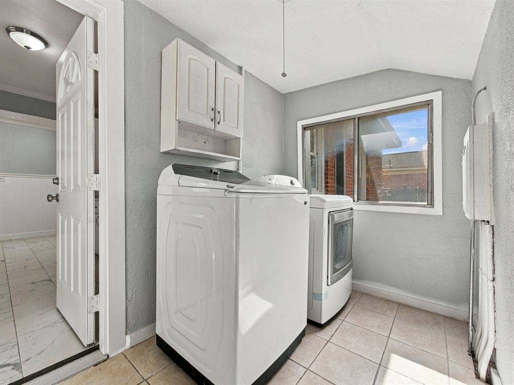 Separate utility room off the kitchen with door to backyard